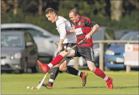  ?? Photograph: Neil Paterson. ?? Oban Camanachd’s Scott MacMillan challenges Lovat’s Lewis Tawse.