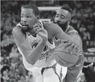  ?? Marcio Jose Sanchez, The Associated Press ?? Warriors forward Kevin Durant, left, drives against Rockets guard James Harden during the second half of Saturday’s Game 6 of the Western Conference finals in Oakland, Calif.