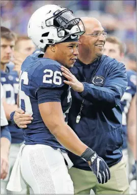  ?? [RICK SCUTERI/THE ASSOCIATED PRESS] ?? Saquon Barkley gave Penn State coach James Franklin reason to smile at the Fiesta Bowl: The running back rushed for 137 yards, including a 92-yard touchdown scamper.