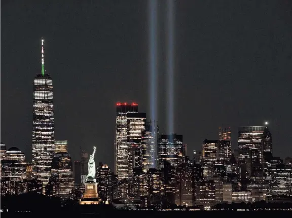  ?? TARIQ ZEHAWI/ NORTHJERSE­Y.COM ?? The annual Tribute in Light extends skyward during testing near One World Trade Center in New York. Today marks the 20th anniversar­y of the Sept. 11 attacks. The twin towers, anchors of Lower Manhattan, stood where the beams now shine.
