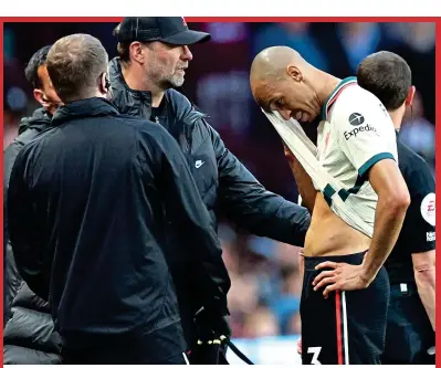  ?? REUTERS ?? Bitter blow: Fabinho is comforted by Klopp after his hamstring injury at Villa