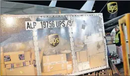  ?? [ASSOCIATED PRESS FILE PHOTO] ?? A UPS airplane is unloaded at the company’s hub in Louisville, Ky., in 2015. UPS says some package deliveries are being delayed this month because of an unexpected flood of online orders after Thanksgivi­ng.