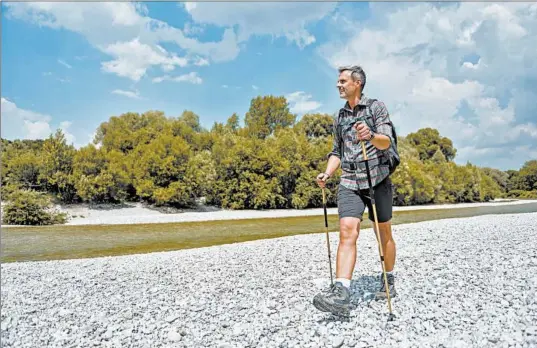  ?? GETTY ?? Walking poles can help take some stress off the knees, researcher­s found.