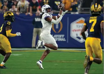  ?? RICK SCUTERI, AP ?? TCU wide receiver Quentin Johnston (1) makes a catch against Michigan during the College Football Playoff semifinal at the Fiesta Bowl on Dec. 31 in Glendale, Arizona.