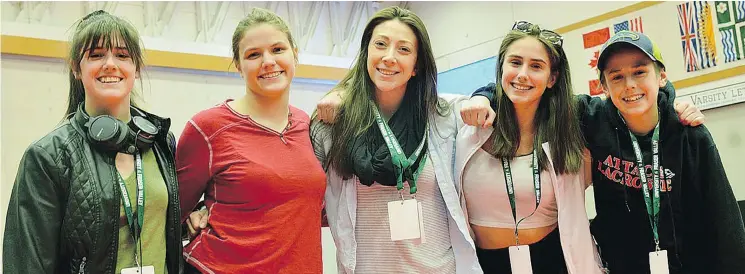  ?? — GARY AHUJA LANGLEY EVENTS CENTRE ?? Ahsley Topnik, centre, coaches the four wrestling Trollands. The high schoolers are, from left, Charisma, 17, Jade, 18, Mikaela, 15, and Talon, 13.