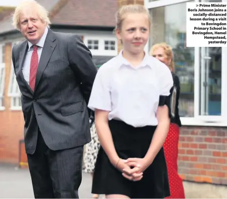  ??  ?? > Prime Minister Boris Johnson joins a socially-distanced lesson during a visit to Bovingdon Primary School in Bovingdon, Hemel Hempstead, yesterday