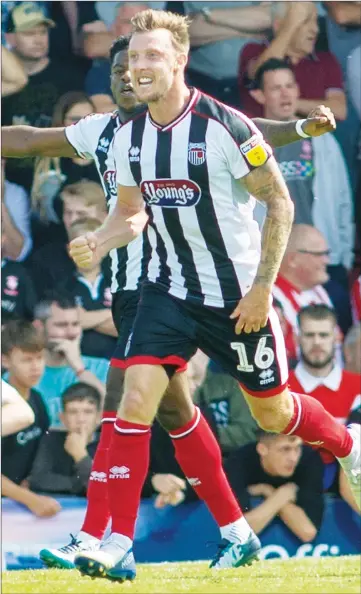  ??  ?? AHEAD: Grimsby midfielder Martyn Woolford celebrates after shooting them into the lead