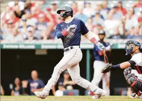  ?? Joshua Gunter / Associated Press ?? The Red Sox’s Trevor Story, left, watches his two-run single against the Guardians in the sixth inning Sunday.