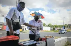  ??  ?? Mzindle and his fiancée Itumeleng Lekaba get ready for the hungry commuters.