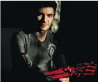  ?? — REUTERS ?? David Aguilar, born without a right forearm, built a prosthetic arm with Lego.