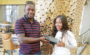  ??  ?? One of the lucky winners of the Club 263 competitio­n, Letty Ndlovu, is presented a bottle of Black Label by Club 263 representa­tive Tatenda Gwatidzo