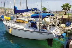  ??  ?? Beauty abounds at the Blue Eye spring (top), which makes for a refreshing dip on a hot summer day. Champagne, a 1972 Dufour 35 (above), Med-moored in Saranda, on the southern coast of Albania.