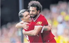  ?? REUTERS ?? Liverpool’s Roberto Firmino, left, and Mohamed Salah.