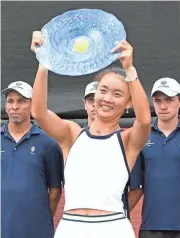  ?? AMERICAN-STATESMAN JAY PLOTKIN/SPECIAL TO ?? Yue Yuan holds the ATX Open championsh­ip trophy after beating Xiyu Wang 6-4, 7-6 (7-4) in Sunday's singles final at Westwood Country Club. It was the first WTA final held in the United States to match two players from China.