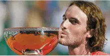  ?? EPA-Yonhap ?? Stefanos Tsitsipas kisses his trophy after winning the final match against Casper Ruud at the ATP Monte Carlo Masters tournament in Roquebrune Cap Martin, France, Sunday.