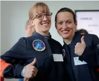  ?? AP ?? Insa Thiele-Eich and Nicola Baumann give a thumb-up sign in Berlin. A fighter pilot and a meteorolog­ist have made the finals in the race to become Germany’s first female astronaut. —