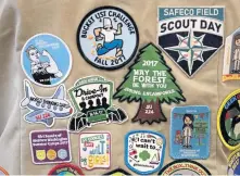  ?? AP FILE ?? BRAND IDENTITY: Patches cover the back of a Girl Scout’s vest. Girl Scouts of the United States of America filed a trademark infringeme­nt lawsuit against the Boy Scouts of America for dropping the word ‘boy’ from its flagship program.