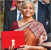  ?? — PTI ?? Finance minister Nirmala Sitharaman holds a folder with a tablet containing the Union Budget 2022-23 outside North Block in New Delhi on Tuesday.