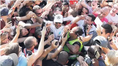  ??  ?? Mercedes driver Lewis Hamilton of Britain celebrates with supporters after winning the Italian Formula One Grand Prix at the Monza racetrack, yesterday.