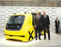  ?? THE ASSOCIATED PRESS ?? VW group CEO Matthias Mueller, left, and CFO Frank Witter pose Tuesday in front of a self-driving concept car prior to the annual media conference of the Volkswagen group in Berlin, Germany.