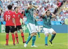  ?? ALEXANDER HASSENSTEI­N GETTY IMAGES ?? Germans Mats Hummels, right, and Mario Gomez react to a play during their World Cup match against South Korea in Kazan, Russia, on Wednesday. Germany lost, 2-0, and the defending champions were eliminated from the tournament.