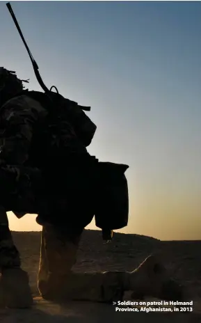  ??  ?? > Soldiers on patrol in Helmand Province, Afghanista­n, in 2013
