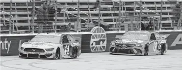  ??  ?? Clint Bowyer (14) and Martin Truex Jr. (19) make their way down the front stretch during the NASCAR Cup Series race Wednesday at Texas Motor Speedway in Fort Worth, Texas. [RICHARD W. RODRIGUEZ/ THE ASSOCIATED PRESS]