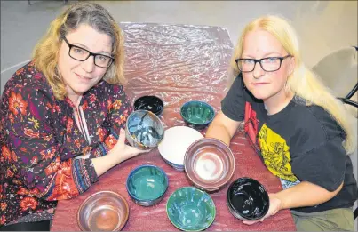  ?? SHARON MONTGOMERY-DUPE/CAPE BRETON POST ?? Elizabeth Burtt-Ivey, left, a potter, and Kimberly McPherson, garden co-ordinator at the Glace Bay Food Bank and also a potter, show some of the bowls they made for the Empty Bowl fundraiser to be held at the Glace Bay fire hall on Oct. 20 to raise...