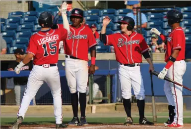  ?? / Jeremy Stewart ?? Rome’s Drew Lugbauer, from left, is greeted at home plate by Jean Carlos Encarnacio­n, Riley Delgado and Derian Cruz after hitting a three-run homer in the fourth inning of a game against Kannapolis on Saturday at State Mutual Stadium.