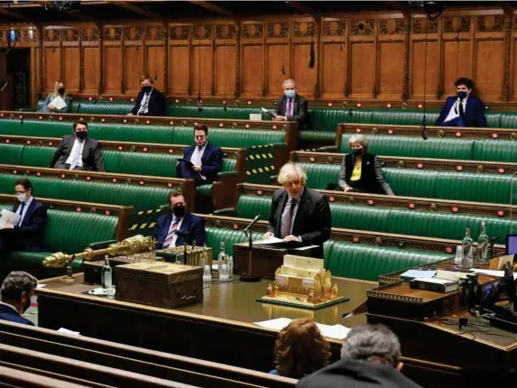  ?? (AFP) ?? Masked MPs sitting two metres apart cannot compete with a rowdy chamber