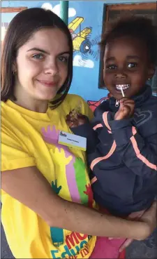  ??  ?? Hollie Corkery with one of the children at the local play school.