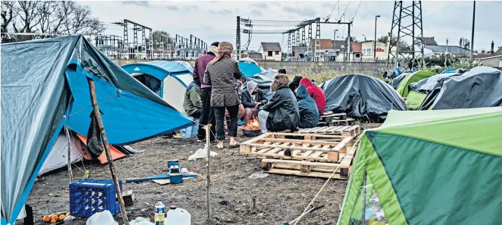  ??  ?? The new ‘Jungle’ in Calais, above, where migrants desperate to reach the UK live in makeshift tents while waiting for an opportunit­y to cross the Channel. Below, Pascal Deborgher sits in the cabin of his boat L’Epervier, which was stolen by people smugglers