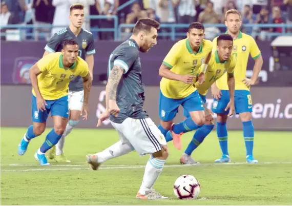  ?? AFP ?? Lionel Messi runs up to take a penalty during the friendly football match between Brazil and Argentina at the King Saud University Stadium in Riyadh on Friday.