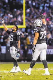  ??  ?? Receiver Michael Crabtree (left) and offensive lineman Austin Howard celebrate late in the second half of the Raiders’ win.