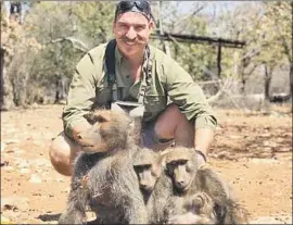  ??  ?? BLAKE FISCHER poses with a family of baboons he killed in Africa. He was pressured to quit the Idaho Fish and Game Commission after his photos surfaced.