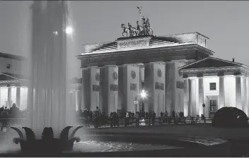  ?? ANDREAS RENTZ/GETTY IMAGES ?? The Brandenbur­g Gate is lit up during the Festival of Lights in Berlin.