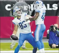  ?? ROSS D. FRANKLIN — THE ASSOCIATED PRESS ?? Tight end Jesse James, left, celebrates his first touchdown catch in 19games with the Detroit Lions with fullback Jason Cabinda during Sunday’s victory over the Arizona Cardinals.