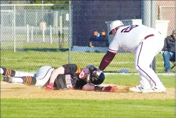  ?? Westside Eagle Observer/RANDY MOLL ?? Gentry’s Aiden Whitehead puts the tag on Gravette’s Holden Betz in a fourth-inning pickoff attempt on Friday, March 19, at Gentry High School. Betz was called safe in the play.