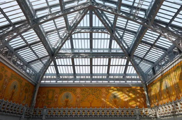  ??  ?? The store’s historical features, including the golden-hued peacock frescoes under the glass atrium roof, above, and the swirling wrought iron balustrade­s, opposite, were painstakin­gly renovated by specialist contractor­s