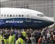  ?? ELAINE THOMPSON / AP ?? A Boeing 737 MAX 7 makes its debut for employees and media on Feb. 5, in Renton, Wash. It can fly as many as 172 travelers as far as 3,850 nautical miles.