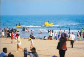  ?? CHEN YEHUA / XINHUA ?? Tourists frolic at the Shimeiwan Beach in Wanning, Hainan province, on Feb 19.