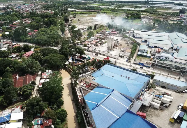  ?? Images by Allan C. Cuizon ?? Butuanon River (see lower half of photo) itself is some 10 kilometers long, but this length stretches to some 34.5 kilometers when its tributarie­s are factored in. There has been talk and some attempts to revive the Butuanon, declared biological­ly dead...