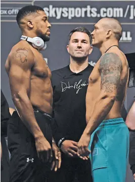  ?? Picture: AFP ?? CALM BEFORE THE STORM. Anthony Joshua (left) and Oleksandr Usyk stare one another down at the weigh-in.