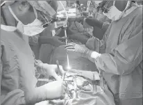  ?? MATT ROURKE/AP 2018 ?? A surgeon directs a special camera to view his patient’s cancerous tumor on monitors while performing surgery at a Philadelph­ia hospital.