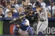  ?? MARK J. TERRILL — THE ASSOCIATED PRESS FILE ?? Astros’ Jose Altuve hits home run against Dodgers during Game 2of World Series in Los Angeles. Altuve was named The Associated Press Male Athlete of the Year on Wednesday.