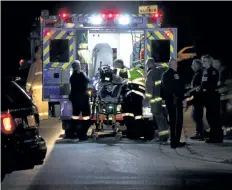  ?? GREG FURMINGER/POSTMEDIA FILE PHOTO ?? A Niagara Regional Police officer is loaded into an ambulance after being shot at a Fenwick apartment building on Oct. 10, 2015. A second officer was also shot. On Thursday police charged Corey Richardson with two counts of attempted murder and other...
