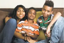  ?? Eamon Queeney / Special to The Chronicle ?? Zecole Thomas and sons Ezekiel, 7 (center), and Joseph, 9, moved out of state after her husband shot himself.