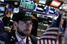  ?? RICHARD DREW — THE ASSOCIATED PRESS ?? Specialist Michael Pistillo wears a “Dow 26,000” hat as he works on the floor of the New York Stock Exchange, Wednesday.