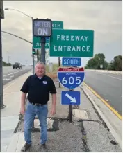 ?? COURTESY PHOTOS ?? Tom Philips, the longtime band director at Lakewood's Mayfair High School, stands near a 605 Freeway sign. The 605 All Star Band he created will march in the 2025 Rose Parade.