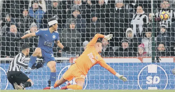  ??  ?? Newcastle United’s Ayoze Perez (left) scores an own goal during the Premier League match at St James’s Park against Leicester City.